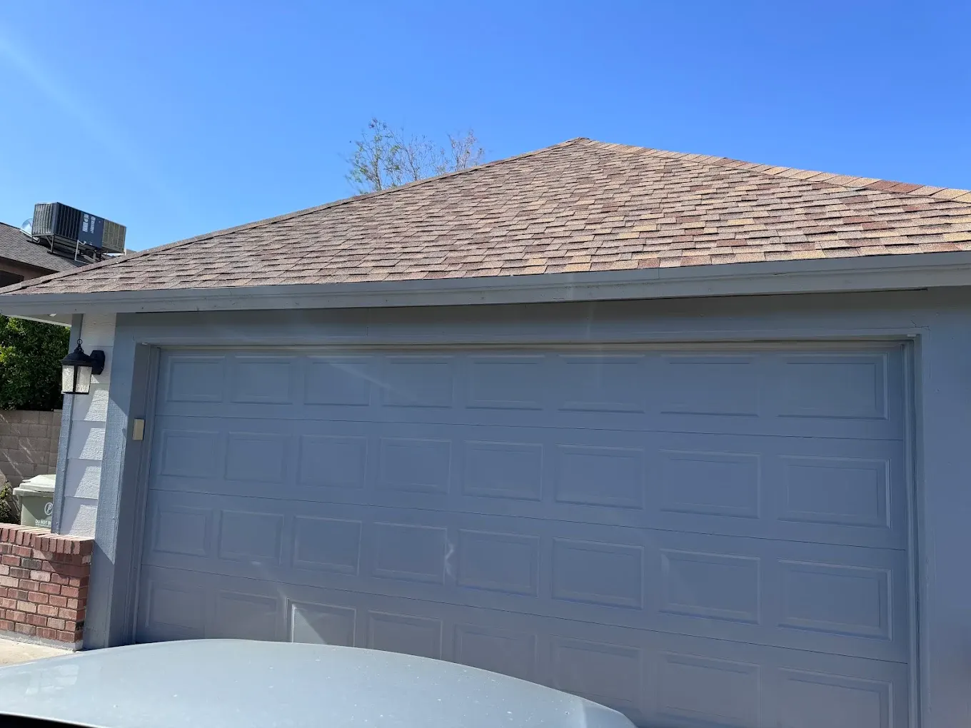 Freshly painted blue-gray garage door and trim
