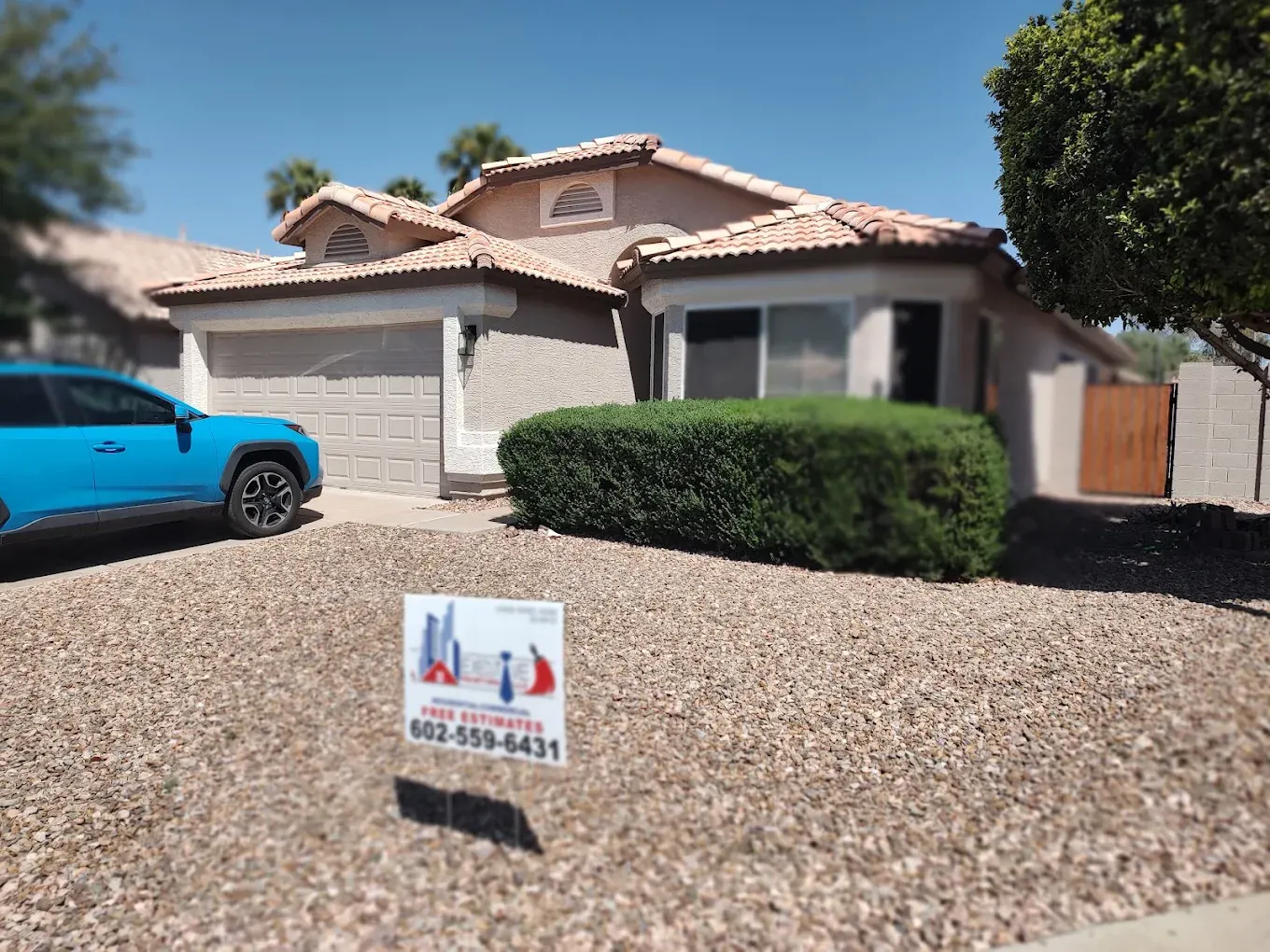 Freshly painted home with an Executive Painting yard sign in the front yard