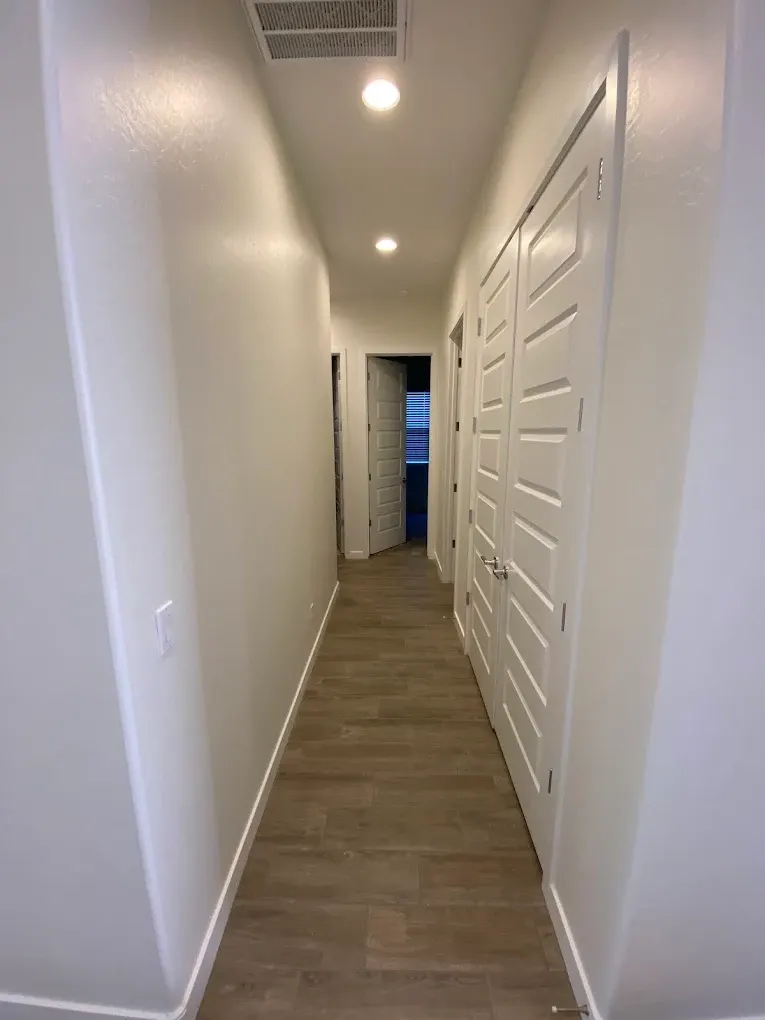 Freshly painted hallway with clean white trim and doors