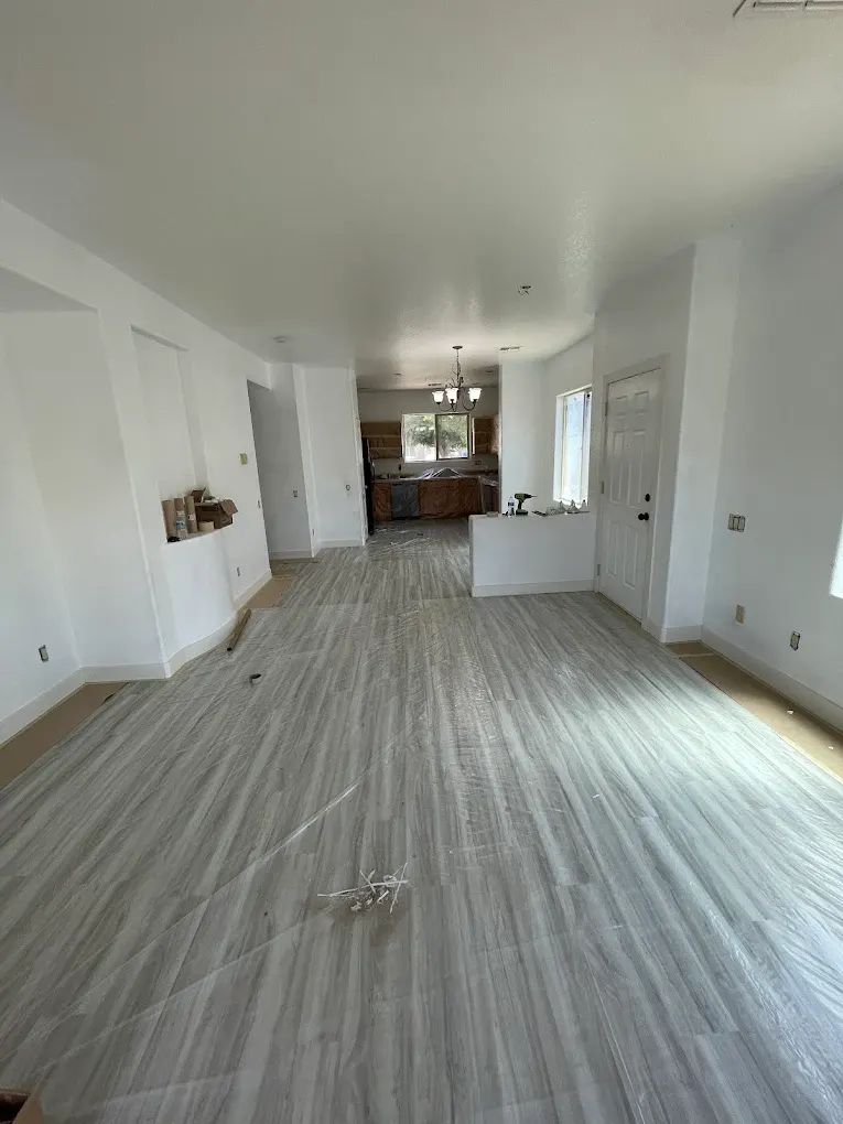 Living area with floors and counters covered and protected before painting